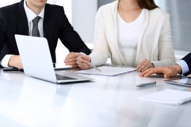 İş adamları modern ofisteki cam masasında birlikte çalışarak sözleşmeyi tartışıyor. İş arkadaşları ya da avukatları olan tanınmamış bir iş adamı ve kadın. Takım çalışması ve ortaklık