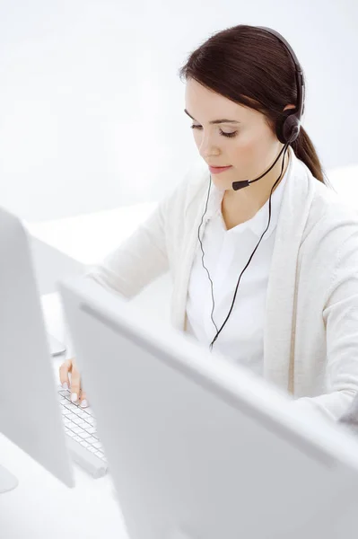 Call center. Casual dressed woman sitting and working in headset at customer service office. Business concept — Stock Photo, Image