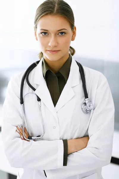 Mujer-médico de pie con los brazos cruzados y mirando a la cámara. Servicio médico perfecto en la clínica. Medicina y asistencia sanitaria — Foto de Stock