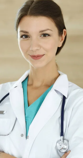 Doctora mujer de pie y mirando la cámara. Médico en el trabajo, retrato de estudio en el fondo médico. Concepto de medicina y salud — Foto de Stock