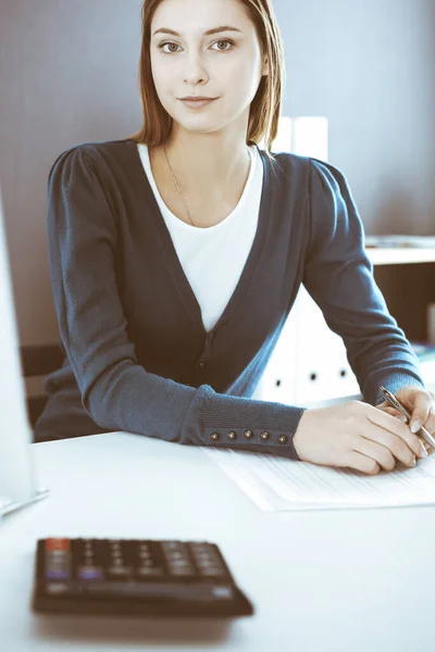 Accountant checking financial statement or counting by calculator income for tax form, hands close-up. Business woman sitting and working at the desk in office. Audit concept — Stock Photo, Image