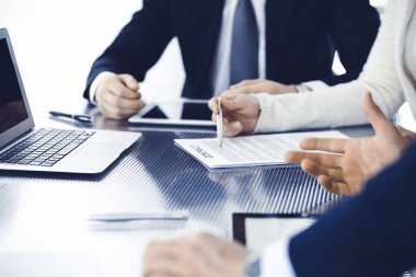 İş adamları modern ofiste birlikte çalışarak sözleşmeyi tartışıyor. Meslektaşları veya avukatları olan tanınmamış işadamı ve kadın görüşmede