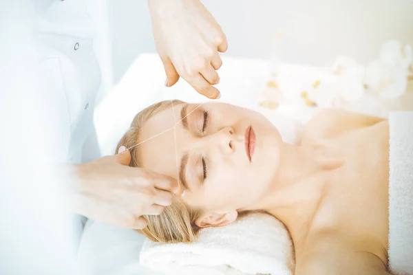 Blonde woman getting face depilation procedure. Beauty and Spa salon concept — Stock Photo, Image