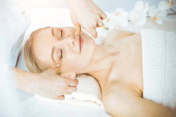 Blonde woman getting face depilation procedure. Beauty and Spa salon concept — Stock Photo, Image