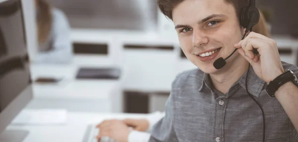 Call center. Group of casual dressed operators at work. Businessman in headset at customer service office. Telesales in business — Stock Photo, Image