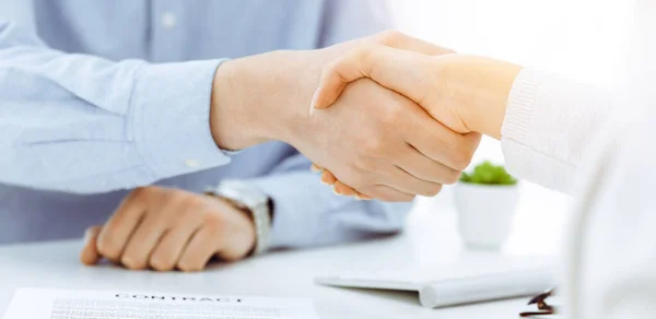 Casual dressed businessman and woman shaking hands after contract signing in sunny office. Handshake concept — Stock Photo, Image