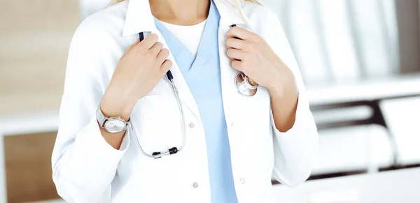 Unknown woman-doctor at work in clinic. Female physician controls medication history record and medical exam results, close-up. Medicine concept — Stock Photo, Image