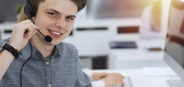 Call center. Group of casual dressed operators at work. Businessman in headset at customer service office. Telesales in business — Stock Photo, Image