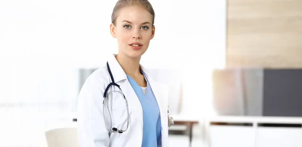 Mujer - doctora sentada en la clínica. Médico en el trabajo, retrato de estudio. Concepto de medicina y salud — Foto de Stock