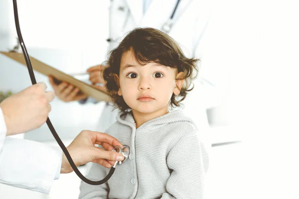 Vrouwendokter die een kindpatiënt onderzoekt met stethoscoop. Leuke Arabische peuter op afspraak bij de dokter. Geneesmiddelenconcept — Stockfoto