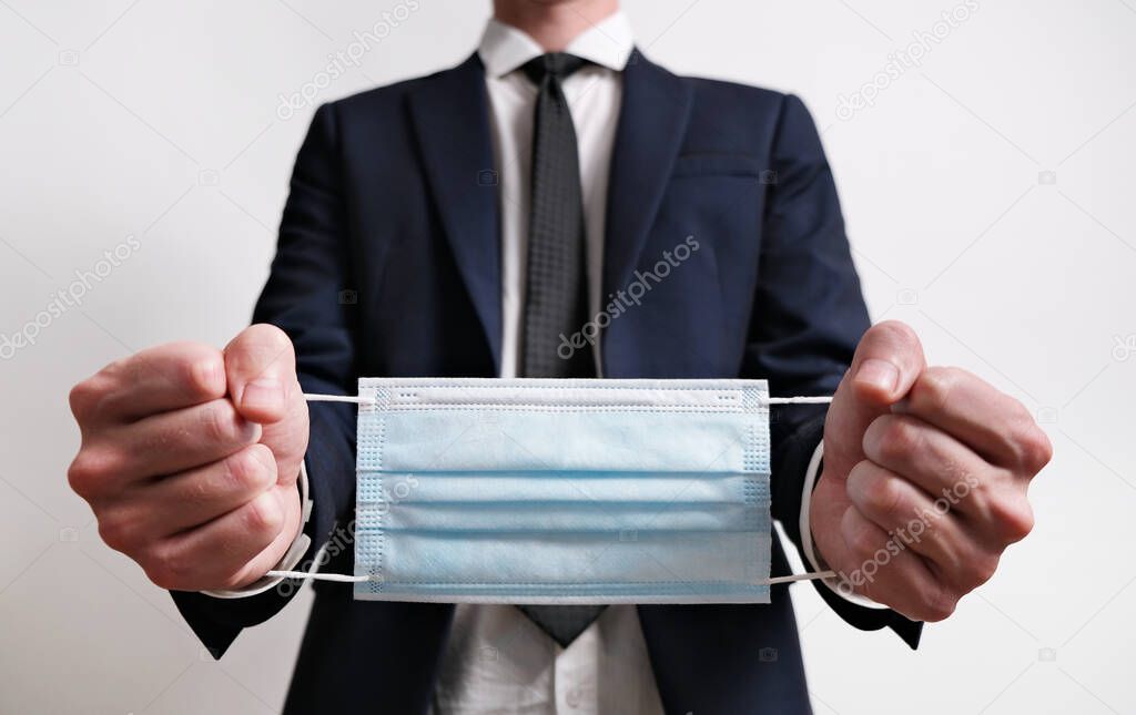 Businessman Hands with Face Mask Bound like handcuffs, Concept of Covid-19