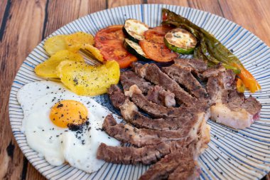 Kızarmış sebzeli et patates ve yumurta.