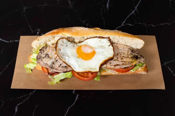 fried egg sandwich baguette with tomato and lettuce