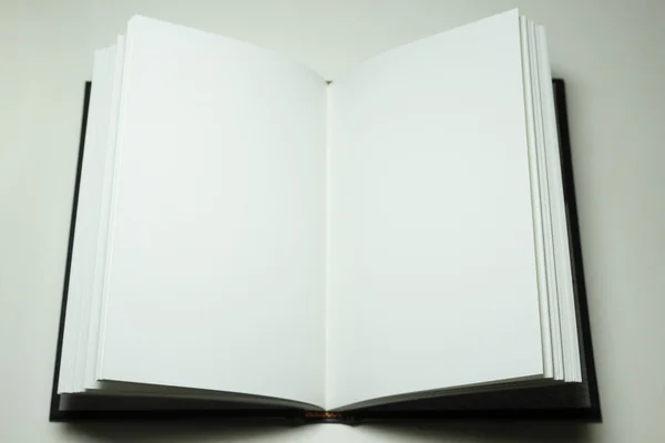 Open hardcover book with blank pages on white surface — Stock Photo, Image