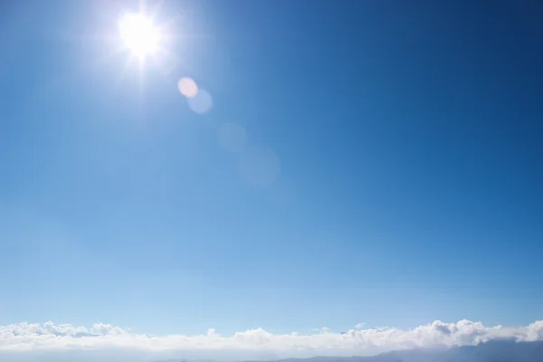 Blue sky with sun and clouds — Stock Photo, Image