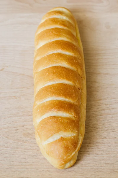 Bread on wooden table — Stock Photo, Image