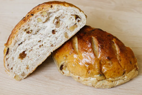 新鲜的全麦面包切成两半在砧板上 — 图库照片