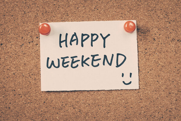 Happy weekend note pinned on the bulletin board