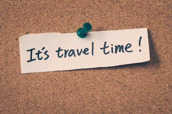 It's travel time note pinned on the bulletin board