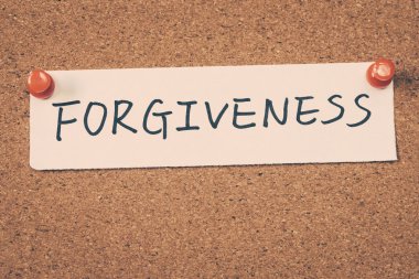 forgiveness note pinned on the bulletin board