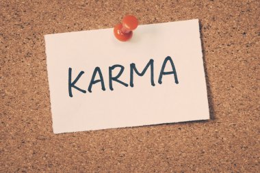 karma note pinned on the bulletin board