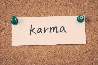 karma note pinned on the bulletin board