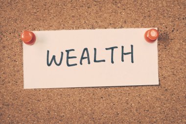 wealth note pinned on the bulletin board