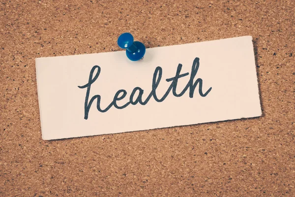 Health note pinned on the bulletin board — Stock Fotó