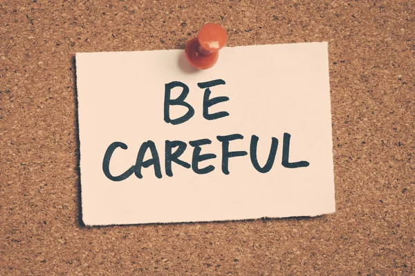 Be careful note pinned on the bulletin board — Stock Photo, Image