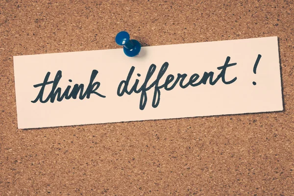 Think different note pinned on the bulletin board — Stock Photo, Image