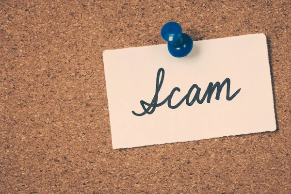 Scam note pinned on the bulletin board — Stock Photo, Image