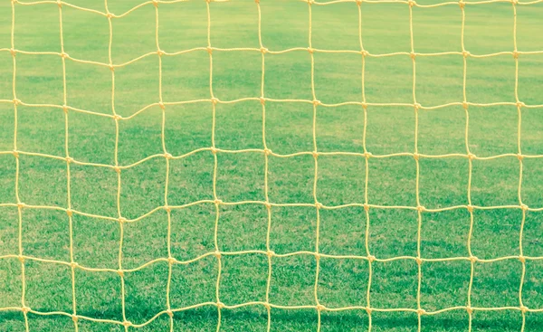 Red de goles con campo de fútbol verde vintage — Foto de Stock