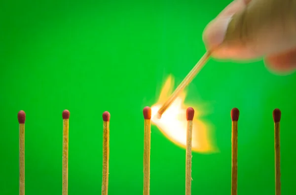 Burnning match setting on green background for ideas and inspira — Stock Photo, Image