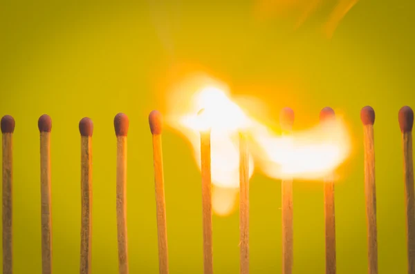 Burnning match setting on yellow background for ideas and inspir — Stock Photo, Image