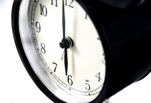 Close-up of a vintage black clock on white background — Stock Photo, Image