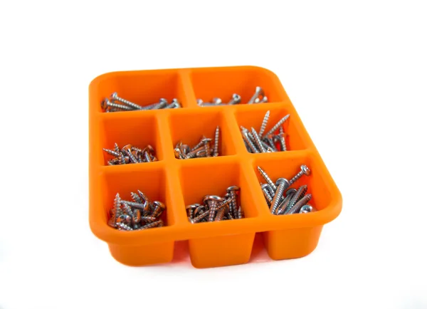 Orange box of screws on white background 01 Stock Image