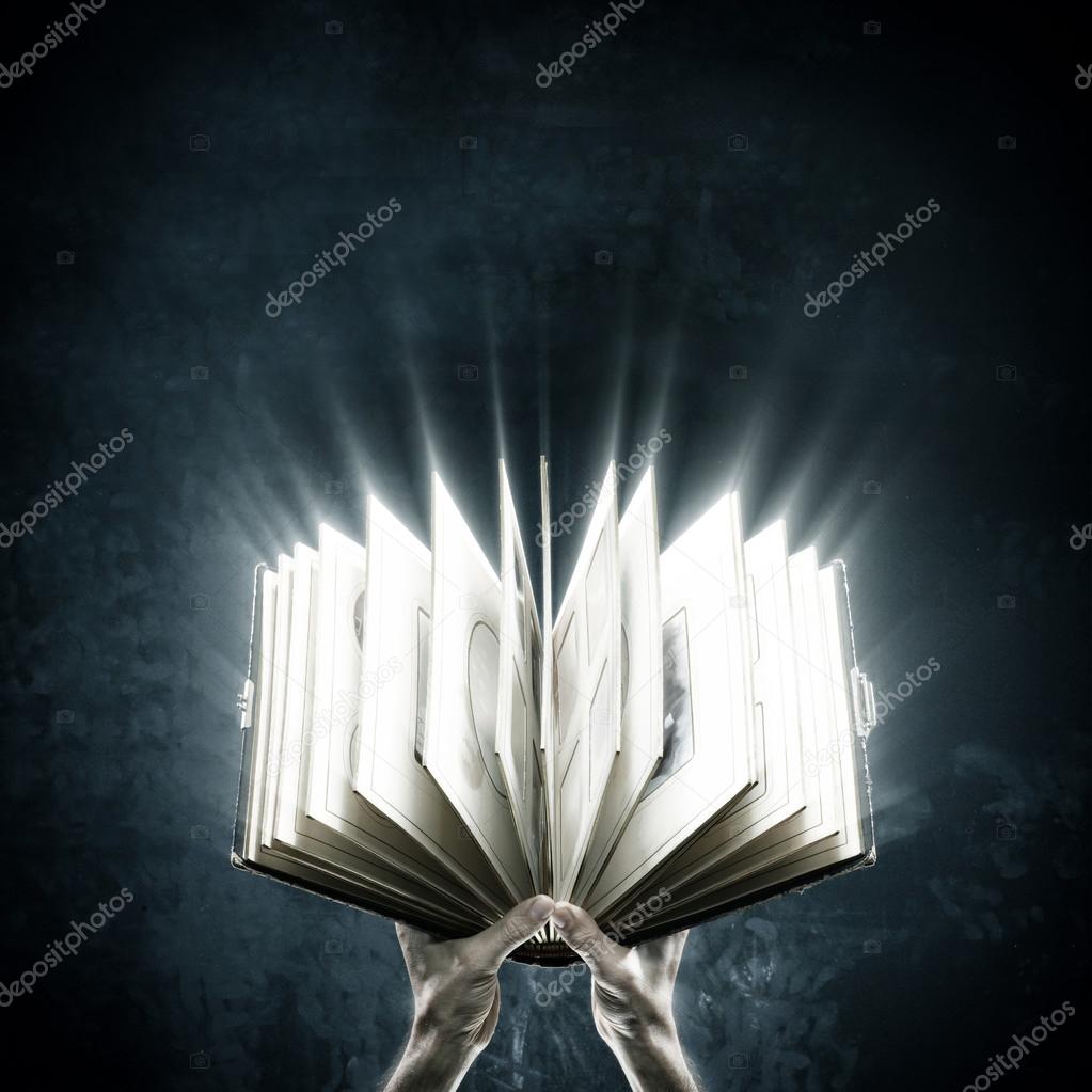 Opened magic book with magic lights