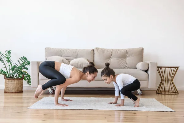 Mom And Daughter On Yoga Workout At Home