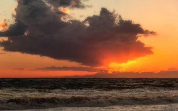 Sunset over the ocean. Stormy weather.