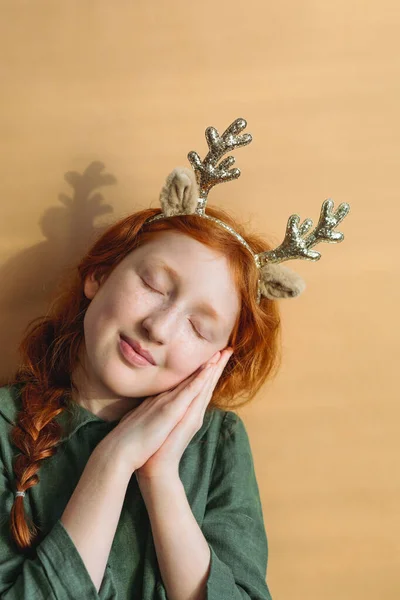 Red Haired Girl Christmas Reindeer Antlers Her Head Simple Background — Stock Photo, Image