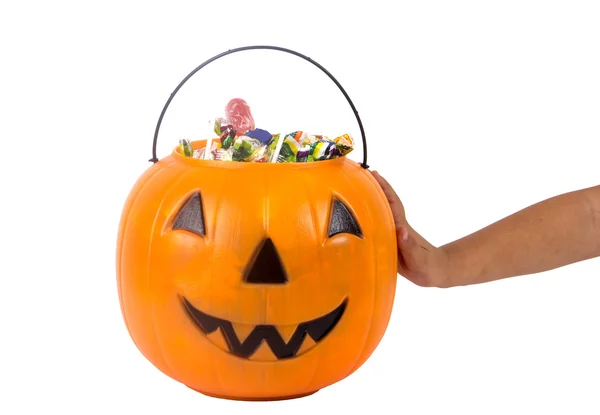 A plastic pumpkin filled with candy isolated — Stock Photo, Image