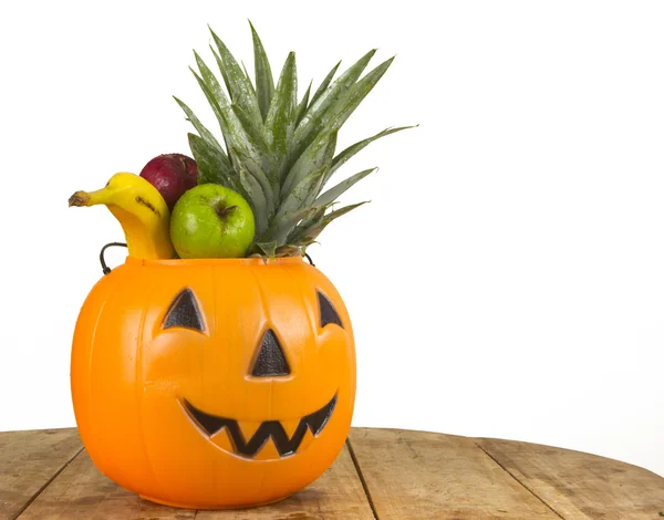 Halloween plastic pumpkin full of fruits — Stock Photo, Image