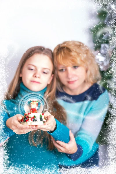 Xmas. Young girl & beautiful woman looking at the   Snowball. Snow & magic effects. Merry Christmas! — Stock Photo, Image