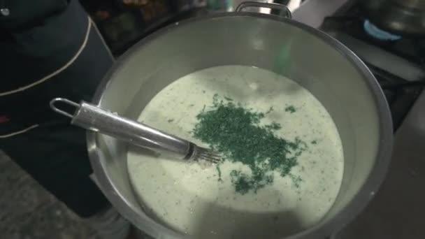 Шеф-повар варит традиционный турецкий суп и добавляет мяты. — стоковое видео