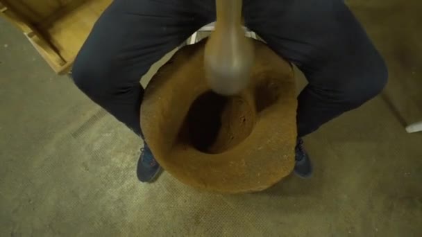 A man beating Turkish coffee with a mallet — Stock Video