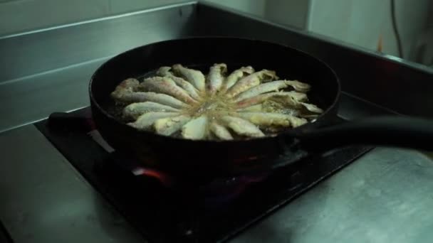 View of cooking frying capelin fish in iron pan — Stock Video