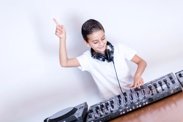 stock image Little boy DJ in headphones mixing up some party music