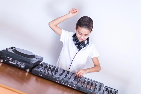 Little boy DJ in headphones mixing up some party music — Stock