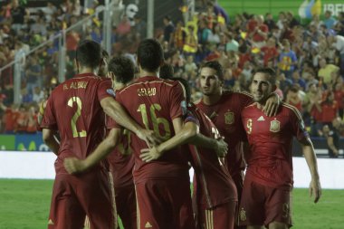 Spain players celebrate after scoring a goal clipart
