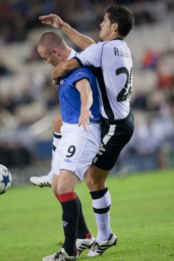 Ricardo Costa (R) and Kenny Miller (L) during the game